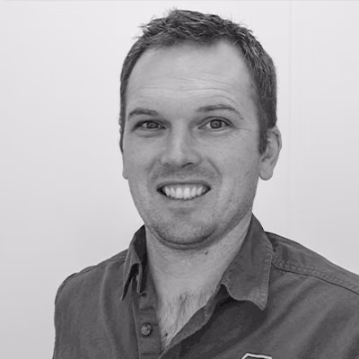 Brendan Roney smiles in a head-and-shoulders portrait.