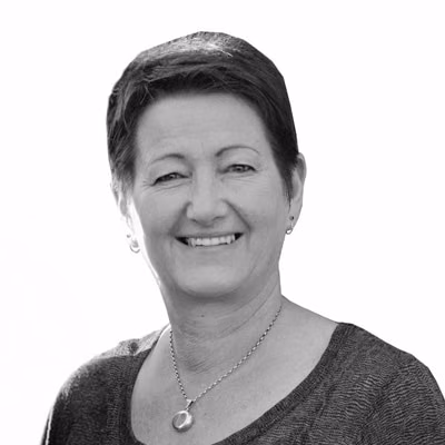 Sheryl Tonkin smiles in a black-and-white head-and-shoulders portrait.